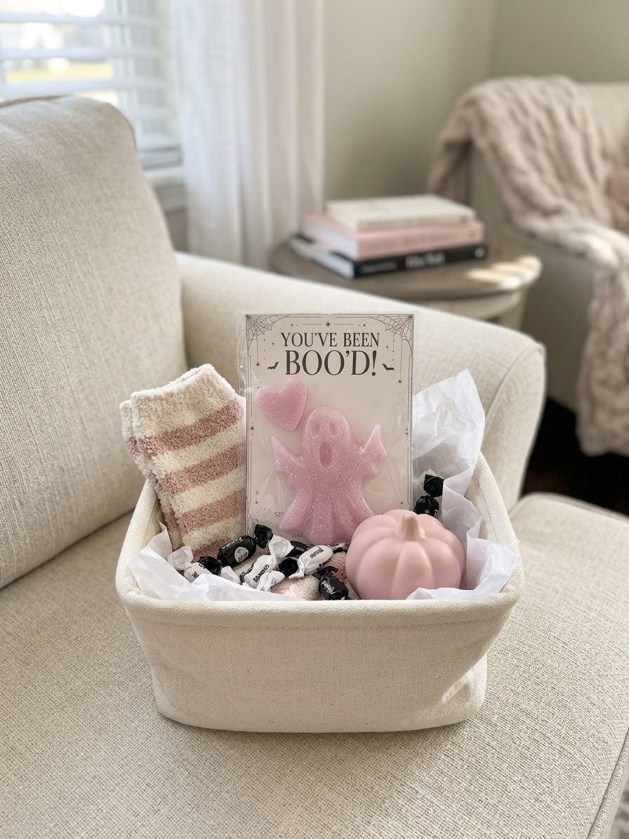Boo basket gift inspiration featuring the pink resin ghost and heart set. Basket, socks, candy, pumpkin, and styling props are not included.