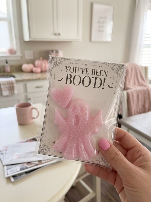 Close-up of the pink glitter resin ghost and heart in a clear sleeve with a You’ve Been Boo’d backing card.